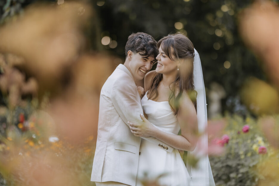 bride and groom giggling in rose garden Tree Church