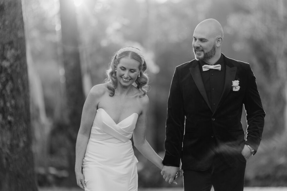 black and white photo of groom looking at bride while she looks down happy