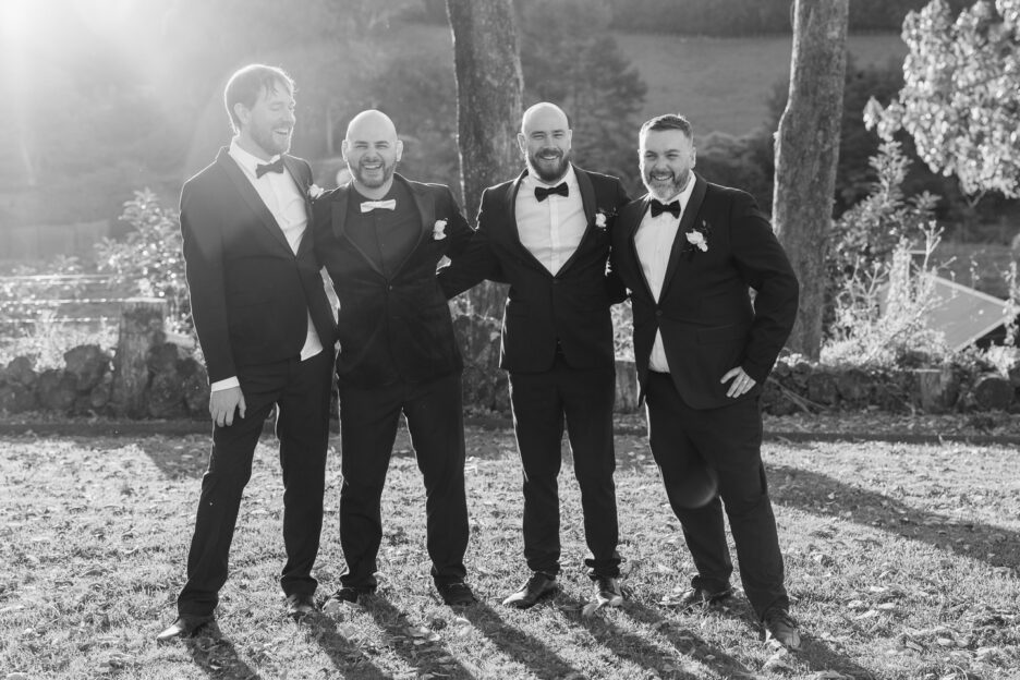 grooms laughs with groomsmen