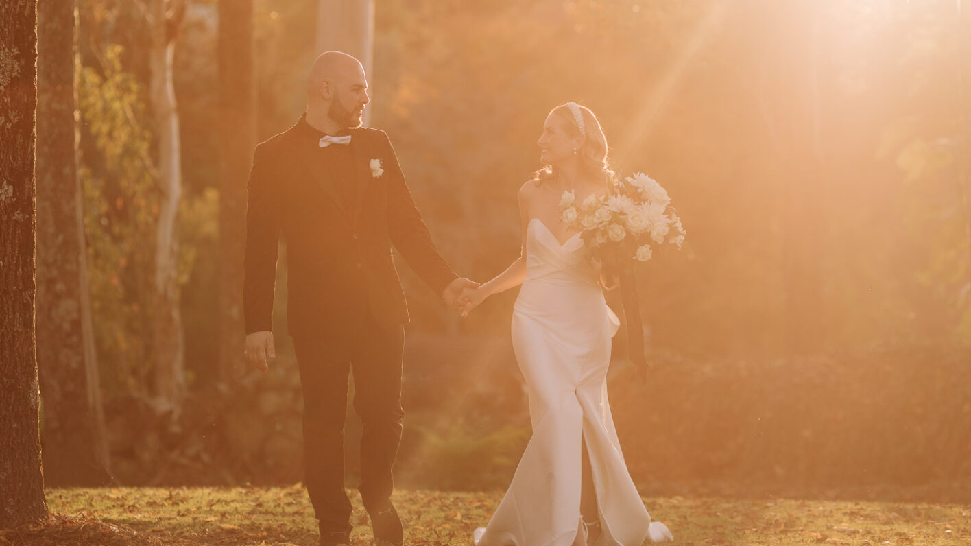 bride and groom in golden light as sun rays come down