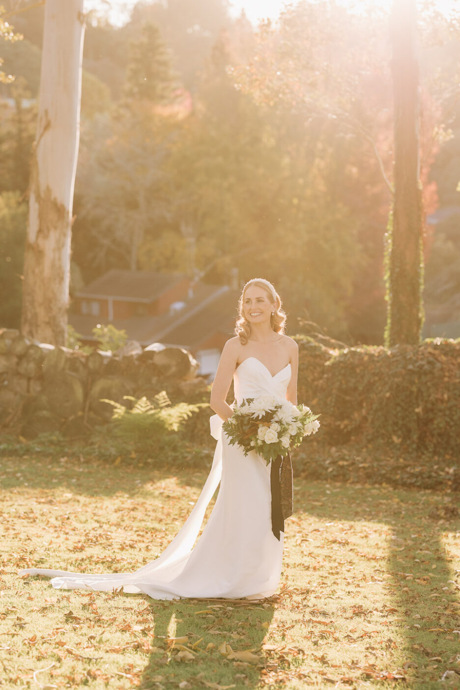 sunlit photo in golden light of bride holding bouquet