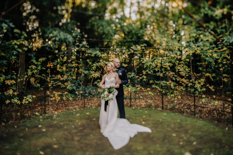 wedding couple hugging in tree church surrounded by greenery