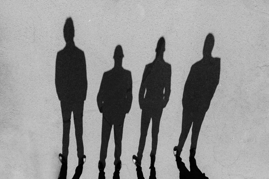 Shadows of four groomsmen in the concrete