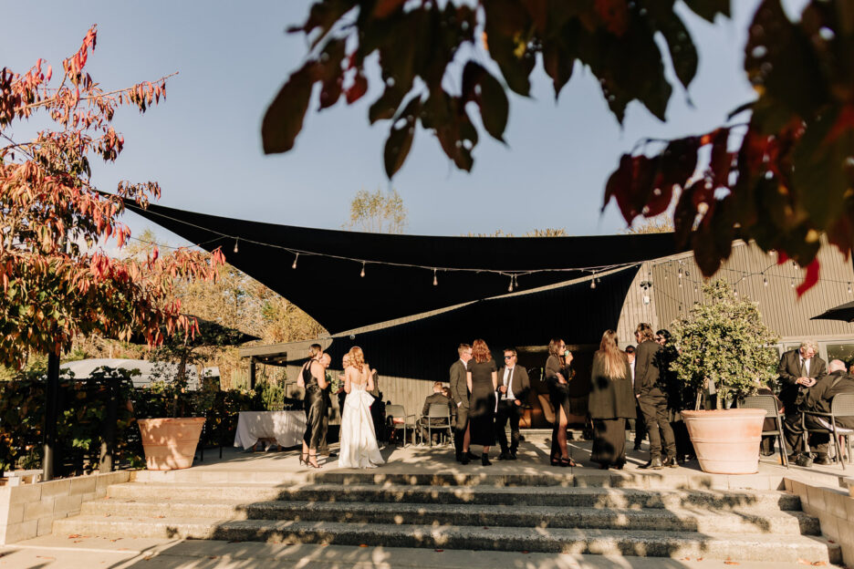 guests enjoying mingling time outside black walnuts reception stairs