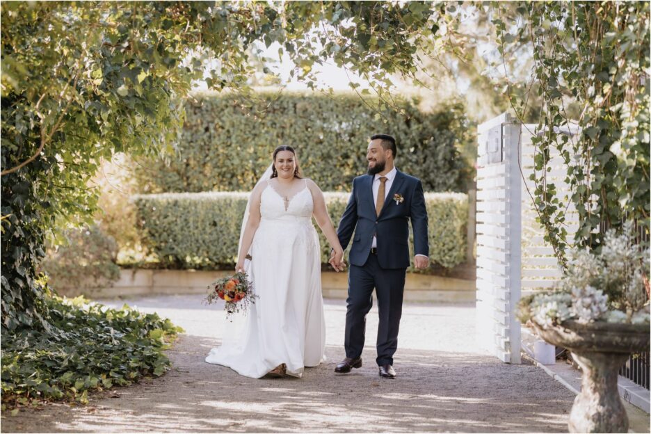 Happy walking in outdoor courtyard bride and groom