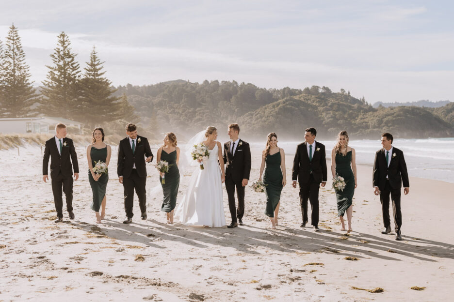 Wedding party walking on waihi beach