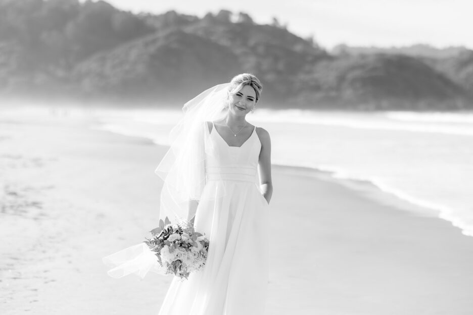 bride looking at camera as walking flat white cafe waihi