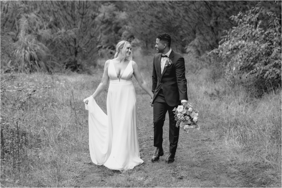 bride and groom walking country lane