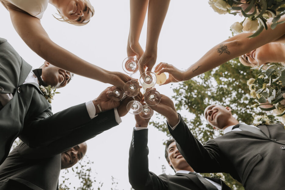 wedding party celebrating cheering glasses old forest school