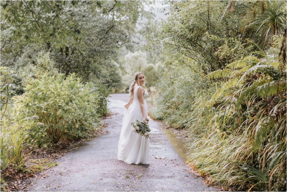 beautiful bride in made with love bridal dress driveway of old forest school