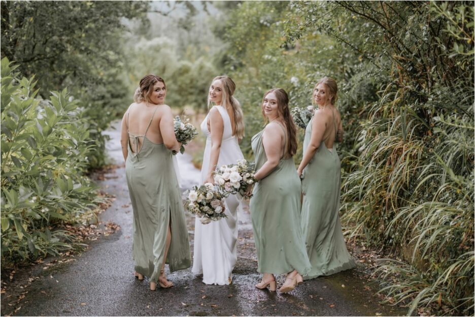 bride with her bridesmaids walking looking over shoulder