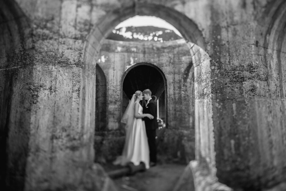 Wedding photo taken vintage style in archway of ruins Waihi New Zealand