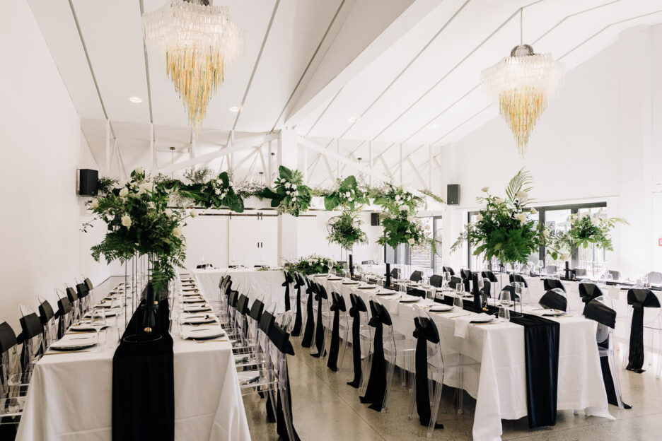 black and white with green white florals reception set up black walnut wedding