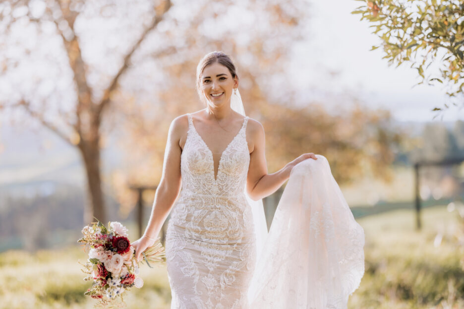 happy bride walking in autumn light in garden