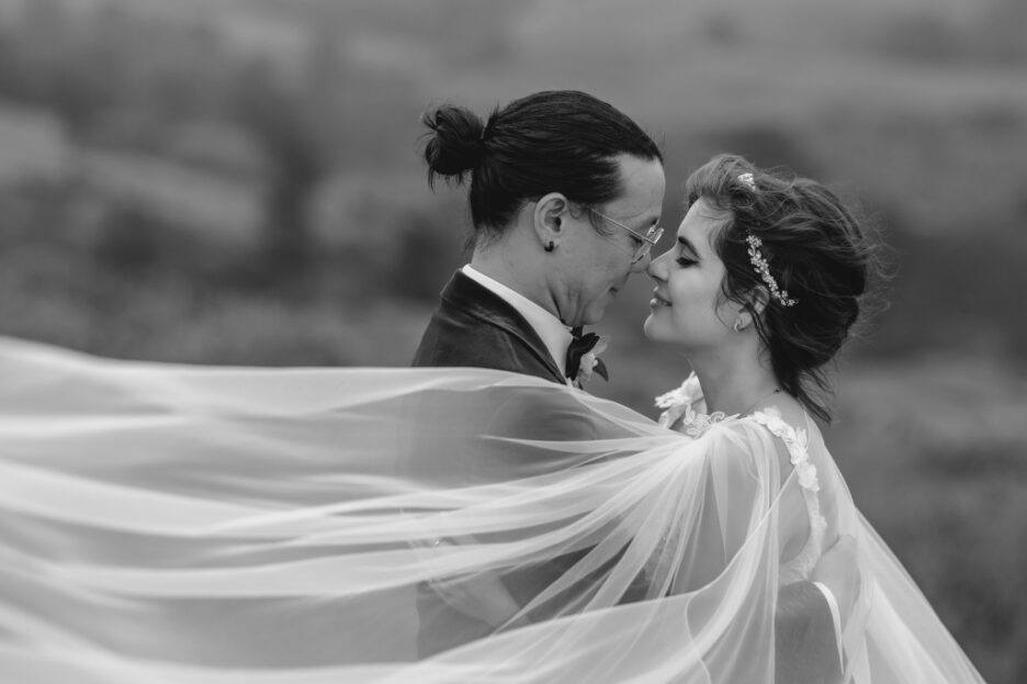 quiet moment for bride and groom as veil flies in wind