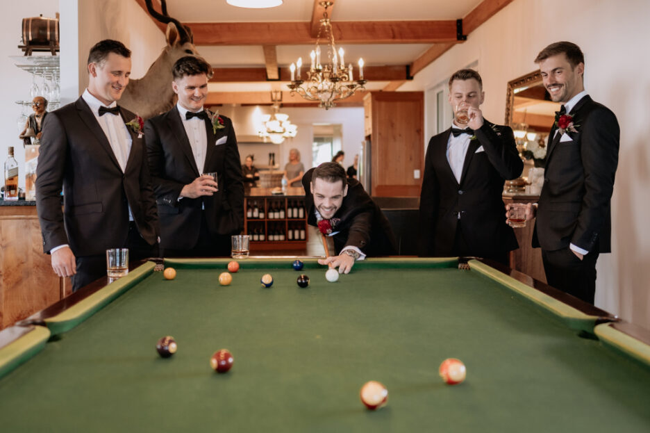 Groomsmen playing pool