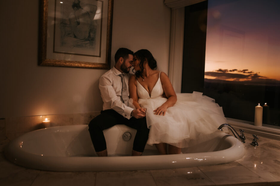 wedding couple with feet in hot water bath candlelight at dusk