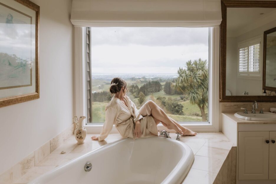 bride sits in window by bath over looking views at eagle ridge estate