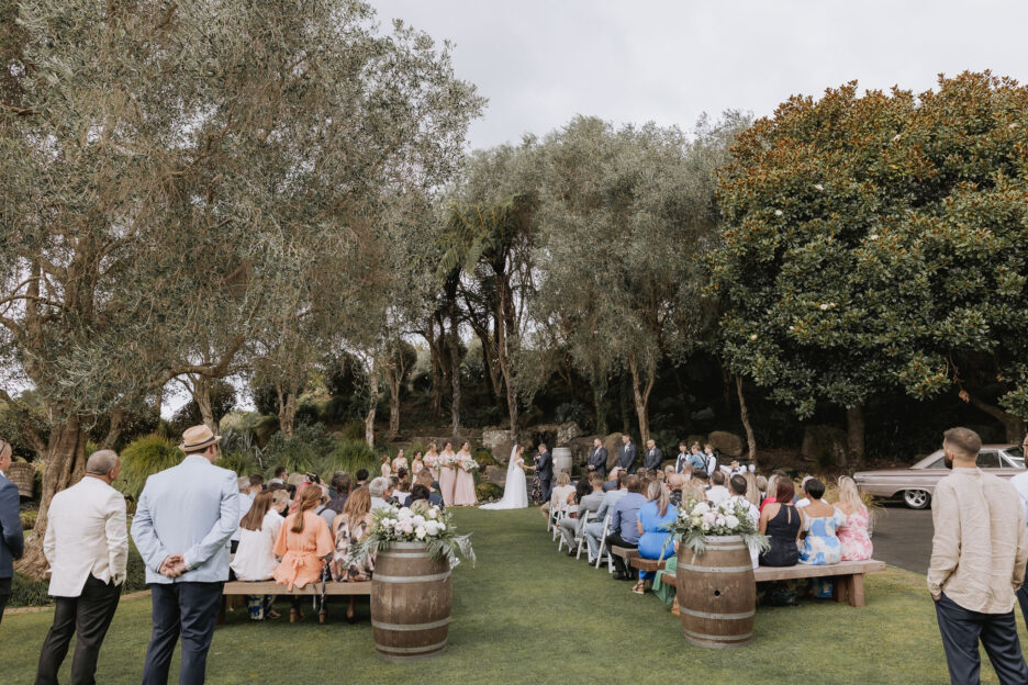 Outdoor Lawn wedding ceremony in front of Rock garden