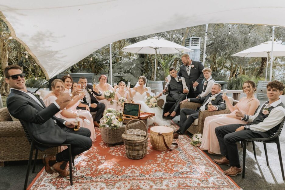 Wedding party enjoying outdoor area by fireplace