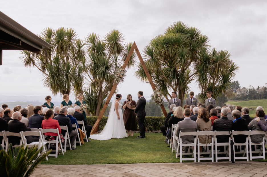 wedding ceremony under arch up at Tauranga country side eagle ridge